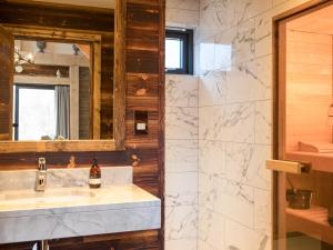 uma casa de banho com um lavatório e um espelho em Macdui Lodge em Aviemore