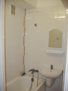 a bathroom with a sink and a tub and a toilet at Darnickiy Bulvar in Kyiv