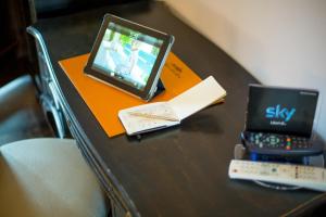 a table with a laptop and a book on it at Agriturismo Il Sapore Della Luna in Monteprandone