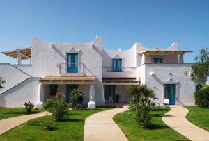 a large white house with a pathway at VOI Marsa Siclà Essentia in Sampieri