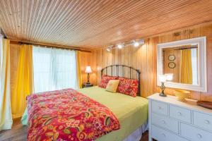 a bedroom with a bed and a dresser and a window at 406 E ARCTIC in Folly Beach