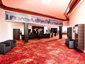 a large room with a red carpet and furniture at Sieben Welten Hotel & Spa Resort in Fulda