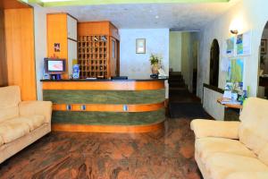 a bar in a living room with two couches at Hotel Loreto in Loreto