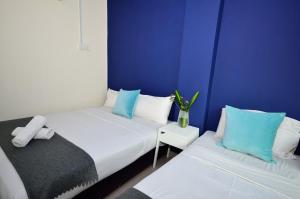 Кровать или кровати в номере Dragon Inn Premium Hotel Johor Bahru