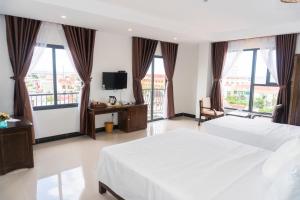 Postel nebo postele na pokoji v ubytování Aries Hotel
