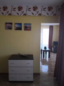 a bedroom with a dresser and a room with a table at Свети Кирил Лозенец in Lozenets