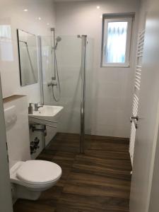 a bathroom with a shower and a toilet and a sink at Apartment Kreuzstraße in Hürth