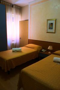 Letto o letti in una camera di Hotel Loreto