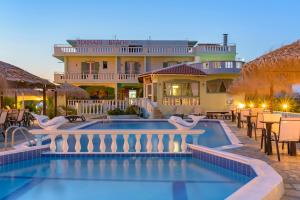 a resort with a swimming pool and a building at Kokkari Beach Hotel in Kokkari