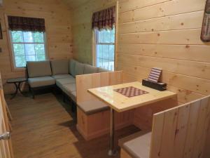 a living room with a couch and a table at Okie Dokie Cabins in Tamworth