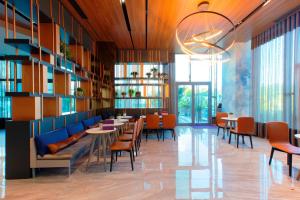 a restaurant with tables and chairs and windows at Mercure Istanbul Umraniye in Istanbul