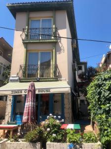 a store with an umbrella in front of a building at Times Apart in Çeşme