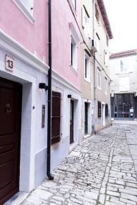 une rue pavée dans une ruelle avec des bâtiments dans l'établissement Apartments Bella Tara, à Piran