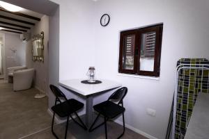 a table and chairs in a room with a window at Apartments Bella Tara in Piran +44 photos