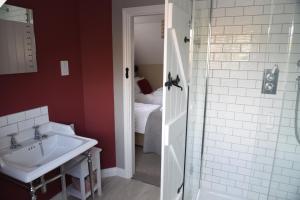 a bathroom with a sink and a shower at The Three Horseshoes in Warham