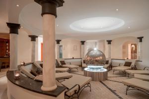 a lobby with chairs and a large ball on the floor at Chalet Silvretta Hotel & Spa in Samnaun