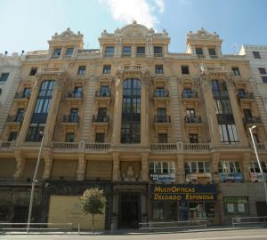 a large building on the corner of a street at Hostal La Selecta in Madrid