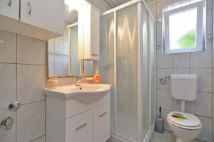 a bathroom with a sink and a toilet and a shower at Apartments Milena 436 in Fažana +58 photos