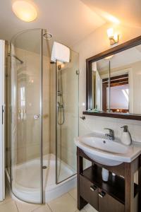 a bathroom with a sink and a shower at Gościniec Na Rozdrożu in Libiąż +22 photos