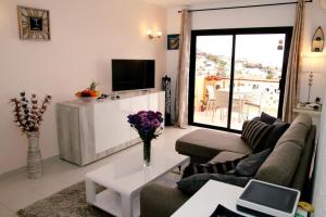 a living room with a couch and a table at Apartment Paradise Court in Adeje