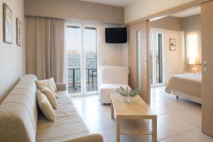 a living room with a couch and a bed at Hotel Philip in Pylos