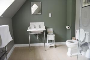 a bathroom with a sink and a toilet at The Three Horseshoes in Warham