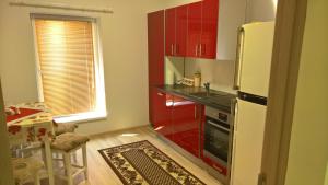 a kitchen with a white refrigerator and a table at Apartman in Velyka Bihan Берегівський район - Закарпаття in Velyka Bihanʼ