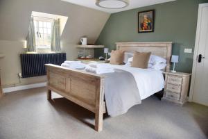 a bedroom with a large bed with towels on it at The Three Horseshoes in Warham