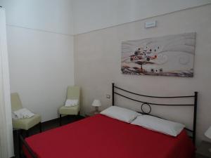 A bed or beds in a room at Nonna Ia B&B