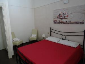 A bed or beds in a room at Nonna Ia B&B