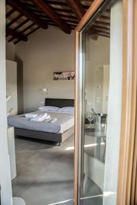 a bedroom with a bed and a glass door at Cerasus B&B in San Marcello