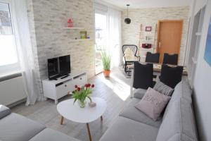 a living room with a couch and a table at Hotel Thode in Dahme