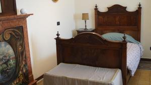 a bedroom with a wooden bed and a fireplace at B&B La Quiete in Albavilla