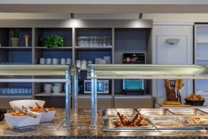 a buffet in a kitchen with food on a counter at RVHotels Nieves Mar in L'Escala