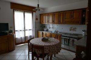 a kitchen with a table with a table cloth on it at Petite Maison 2 in Senin