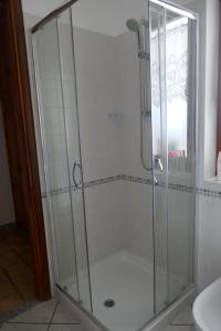 a shower with a glass door in a bathroom at Petite Maison 2 in Senin +14 photos