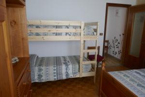 a bedroom with two bunk beds and a staircase at Petite Maison 2 in Senin