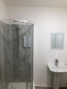 a bathroom with a shower and a sink at Wellington Tavern Accommodation in Dewsbury