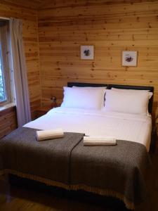 a bedroom with a bed with two towels on it at Dulnain in Aviemore