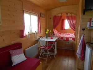a small room with a table in a log cabin at La Canfouine in Lamballe