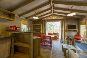 a kitchen and living room with a table and chairs at Lodging Le Lac in Lacanau