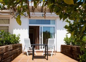 two chairs and a table on a patio at Camping Villasol in Benidorm