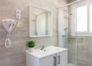 a bathroom with a white sink and a shower at Camping Villasol in Benidorm