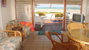 a living room with a view of the beach at Aruba Beach Villas in Palm-Eagle Beach