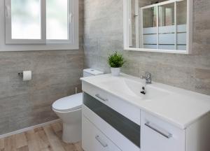 a bathroom with a white sink and a toilet at Camping Villasol in Benidorm