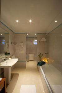 a bathroom with a tub and a sink and a shower at Apartamentos Marina Turquesa in Nerja