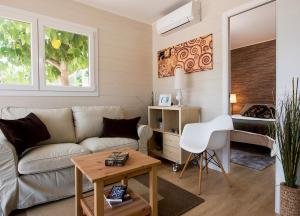 a living room with a couch and a bed at Camping Villasol in Benidorm