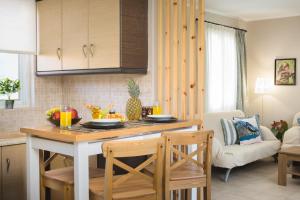 a kitchen with a table and chairs in a room at Villa Provenza in Anafonítria