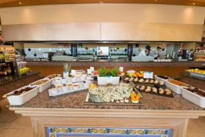 a buffet line in a grocery store with food at Gloria Palace Royal Hotel & Spa in Puerto Rico de Gran Canaria