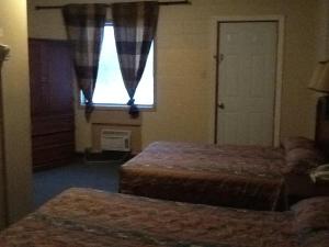 Postel nebo postele na pokoji v ubytování Motel Du Parc Masson